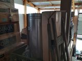 a pile of boxes and a ladder in a room
