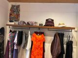 many clothes hanging on a rack in a clothing store