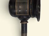 a black and gold wall mounted lamp on a white wall