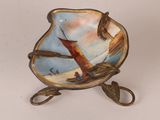 a small plate that has a picture of a sailboat on it