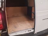 a white van with the door open in a garage