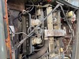 a very old engine in the back of a truck