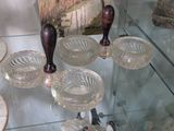 a glass display case filled with glass dishes and vases