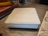 a mattress that is sitting on the floor in the living room