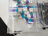 a clear box with a blue and white model of a spaceship