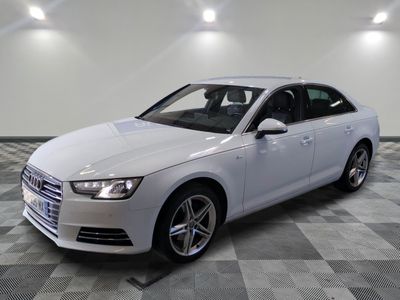 the white audi sedan is parked in a clean room