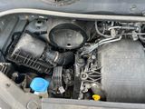 a car engine with the hood open and a blue bottle in it
