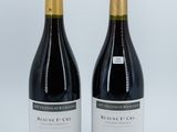 two bottles of wine sitting next to each other on a white surface