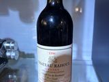 a bottle of wine sitting on a glass shelf