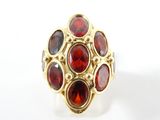 une image représentant une bague en or sertie de grenats