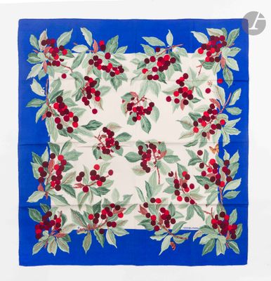 a close up of a blue and white square with red berries on it