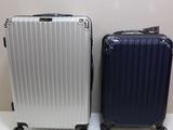 two pieces of luggage sitting next to each other on a table