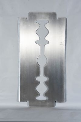 a close up of a razor blade on a metal plate