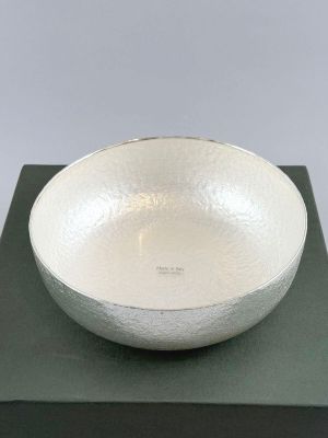 silver bowl on a black box with a white background