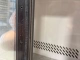 a close up of a person taking a picture through a glass door