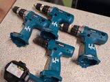 four electric tools sitting on a counter next to each other