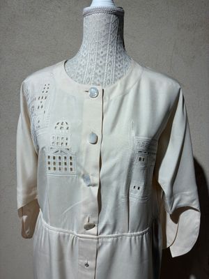 a mannequin on a mannequin stand with a white shirt on it