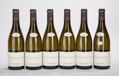 six bottles of wine are lined up in a row on a table