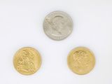 three different types of coins are shown on a white surface
