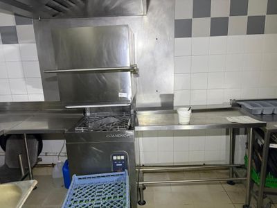 a large stainless steel kitchen with a sink and a stove