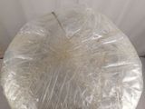 a plastic bag wrapped around a glass vase on a table