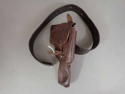 a brown leather holster on a white table