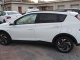 a white car that is parked in a parking lot