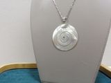a close up of a necklace on a mannequin on a table