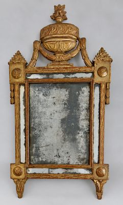 an antique mirror with a gold frame and a bird on top