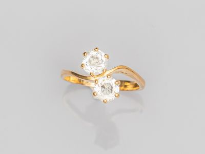 a yellow gold ring with two white diamonds