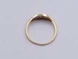 a close up of a gold ring on a white surface