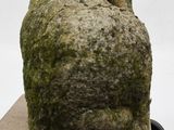a stone sculpture of a head on a skateboard