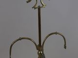 an antique brass oil lamp with a chain hanging from it ' s neck