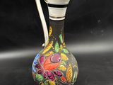 an image of a vase with a floral design on it