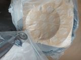 two bags of toilet paper on the floor next to a toilet