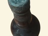 a close up of a bottle on a white surface