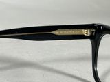 a close up of a pair of glasses on a white surface