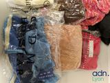 many different types of clothing wrapped in plastic bags