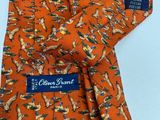 an orange neck tie with a bird design on it