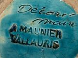 a close up of a blue plate with writing on it