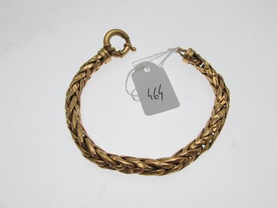 a close up of a gold bracelet with a price tag on it