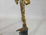 statue of a woman holding a fan on a marble base