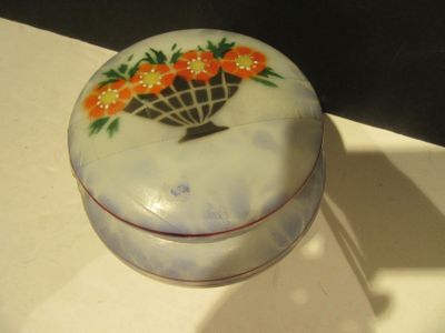 a white box with orange flowers on it on a table