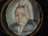 portrait of a woman in a bonnet and fur coat in a gold frame