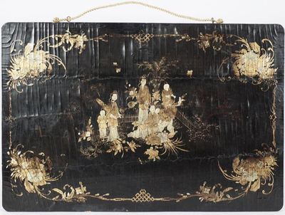 an image of a large black and gold painted box with flowers