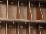 a wooden shelf with a lot of books on it