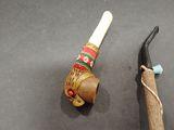 a wooden pipe and a hammer on a table