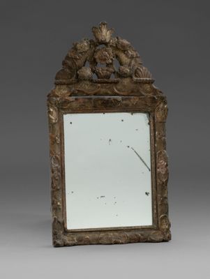 un miroir orné d'un oiseau et d'une horloge au centre