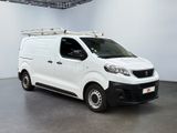 the white van is parked in a large room with a roof rack