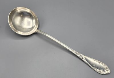a close up of a spoon on a table with a gray background